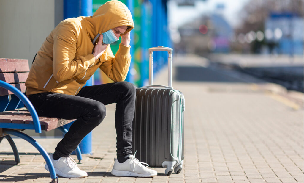 American travelers rushing through an airport amid the 2025 revenge travel surge.