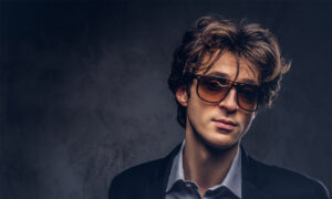 Stylish man wearing trendy eyeglasses showcasing modern men’s eyewear fashion